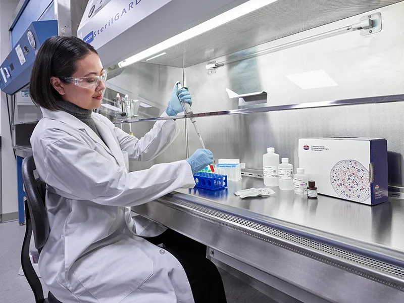 scientist pipetting samples in lab